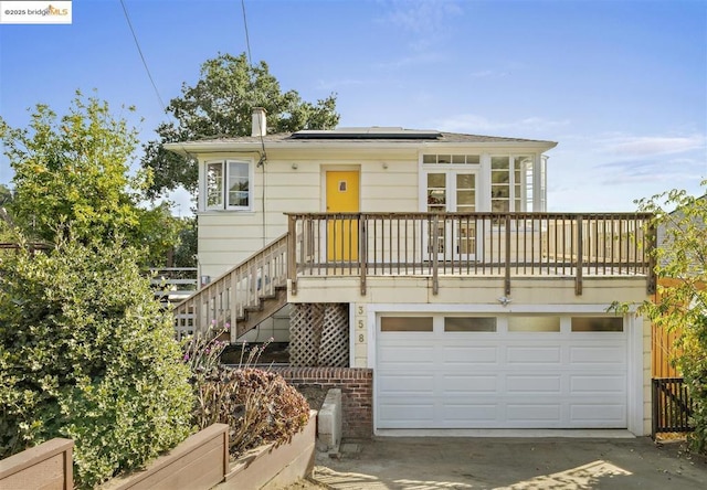 view of front of home featuring solar panels and a garage