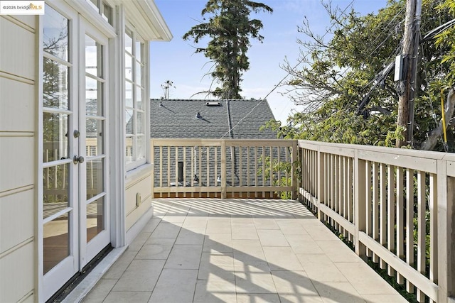 balcony featuring a patio area and french doors