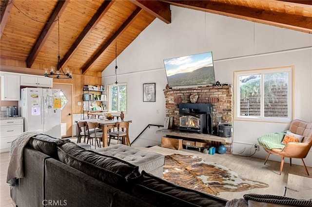 living room with wooden ceiling, a wealth of natural light, light hardwood / wood-style flooring, and beamed ceiling