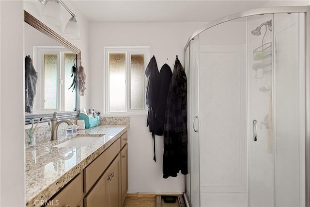 bathroom with walk in shower and vanity