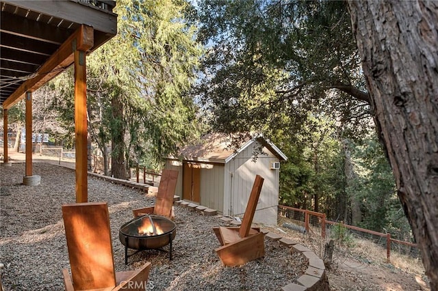 view of patio featuring a storage unit and a fire pit