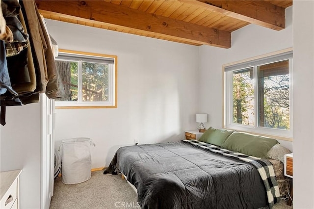 carpeted bedroom featuring wood ceiling and beamed ceiling