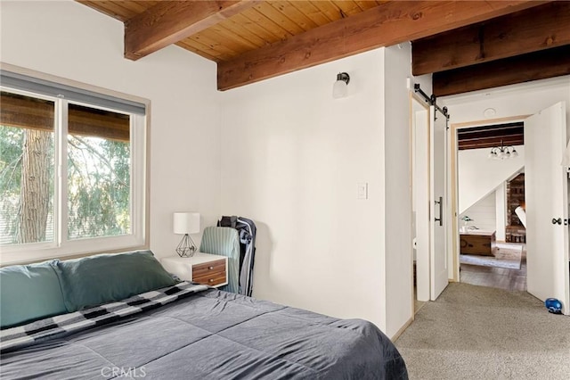 bedroom featuring a barn door, beamed ceiling, carpet flooring, wood ceiling, and a closet