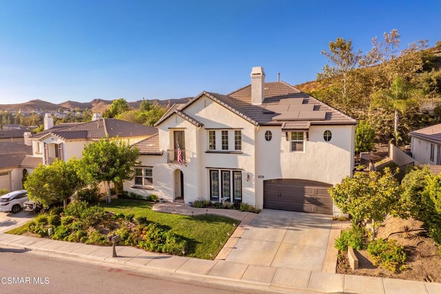 view of front facade featuring a garage and a mountain view