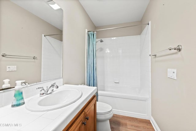 full bathroom with shower / tub combo with curtain, hardwood / wood-style floors, vanity, and toilet