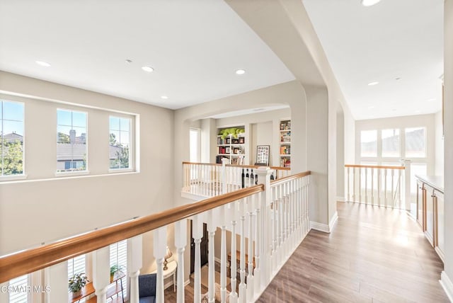 hallway with light hardwood / wood-style floors