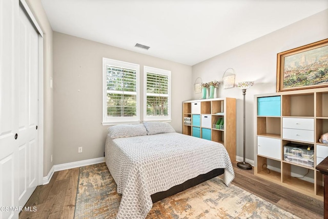 bedroom featuring hardwood / wood-style floors and a closet