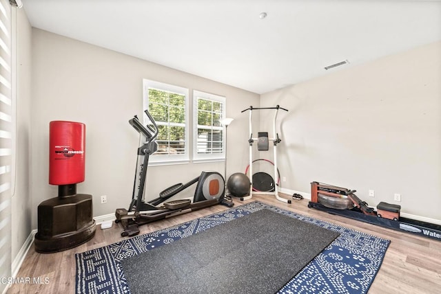 workout room with hardwood / wood-style floors