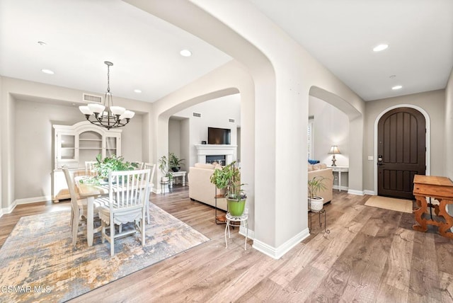 dining room featuring light hardwood / wood-style floors and a notable chandelier