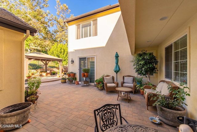 view of patio / terrace with an outdoor living space and a gazebo