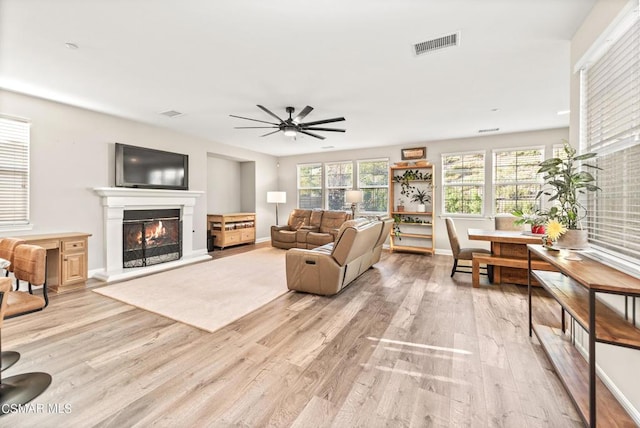 living room with ceiling fan and light hardwood / wood-style floors