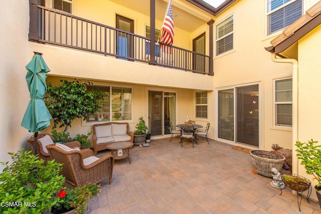 view of patio with a balcony and outdoor lounge area