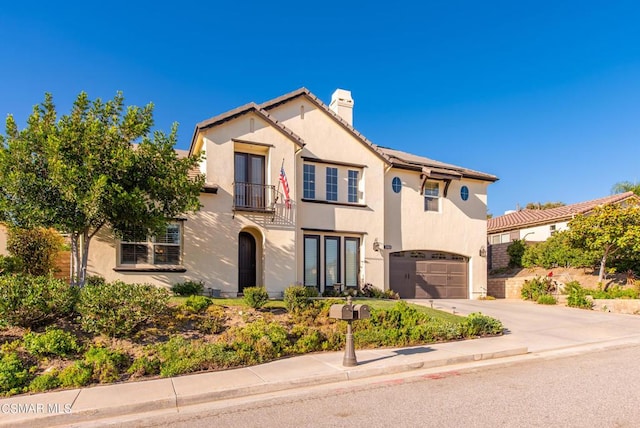 mediterranean / spanish house featuring a garage