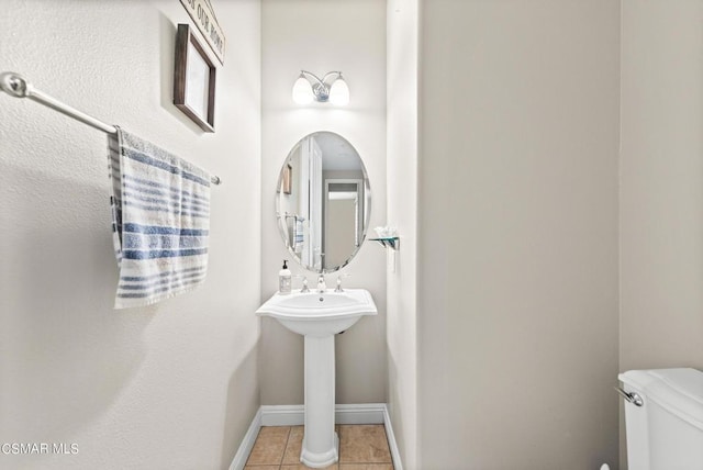 bathroom with tile patterned floors and toilet