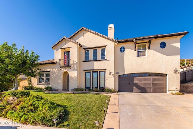 mediterranean / spanish-style home featuring a garage and a front yard