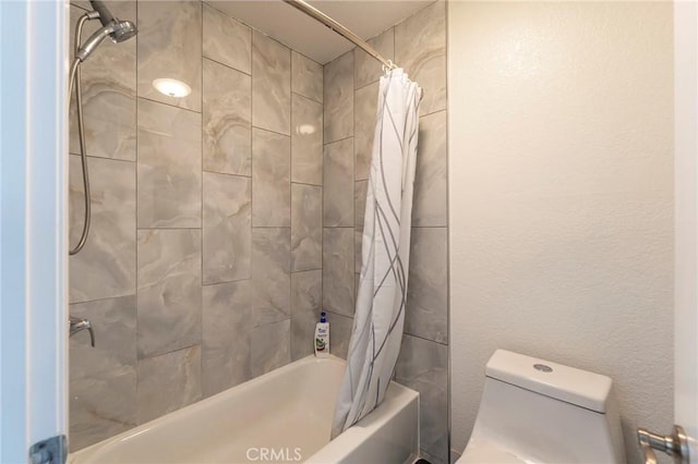 bathroom with toilet and shower / bath combo with shower curtain