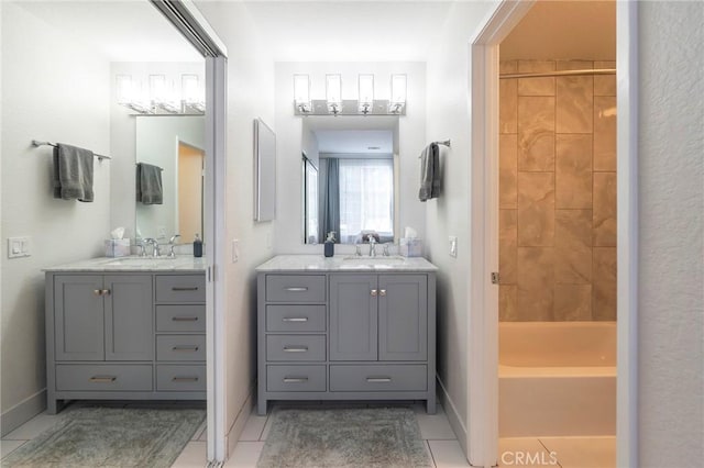 bathroom featuring vanity, bathtub / shower combination, and tile patterned flooring