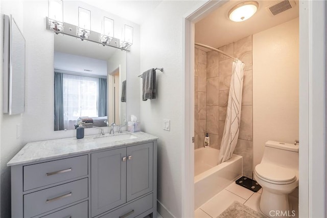 full bathroom featuring tile patterned flooring, vanity, shower / bath combo with shower curtain, and toilet