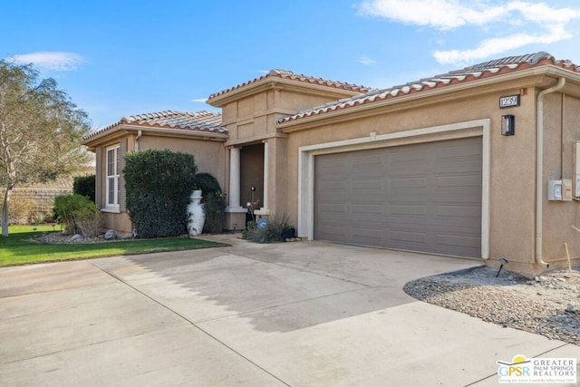 mediterranean / spanish home with a garage