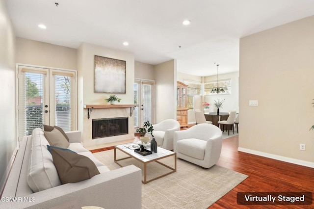 living room with hardwood / wood-style floors and a chandelier