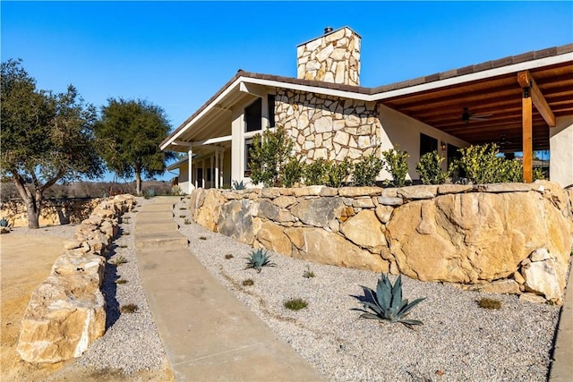 view of property exterior featuring ceiling fan