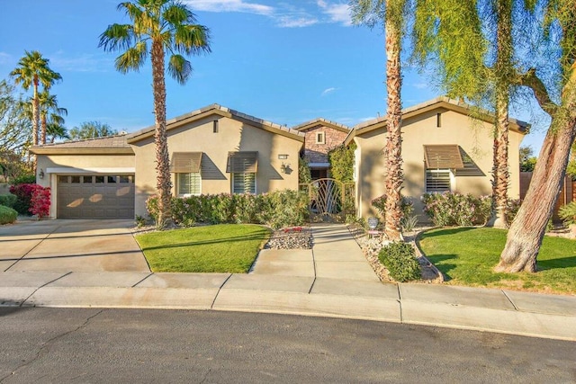 mediterranean / spanish-style house with a garage and a front lawn