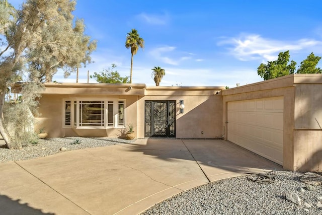 pueblo-style home featuring a garage