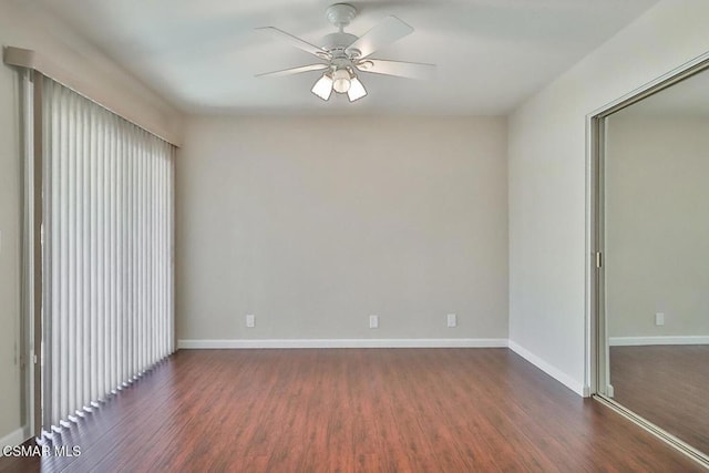 empty room featuring ceiling fan and dark hardwood / wood-style flooring