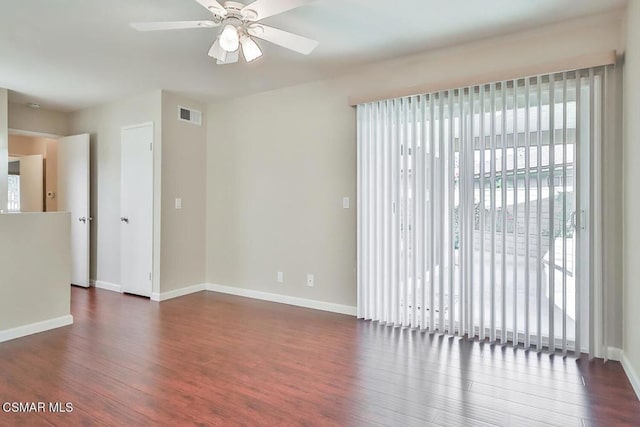 empty room featuring ceiling fan and dark hardwood / wood-style floors