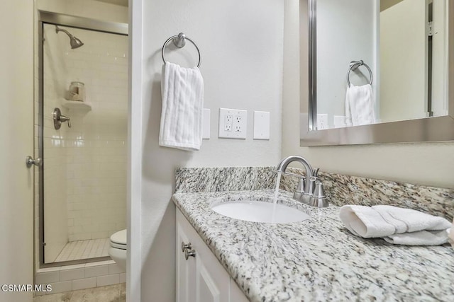 bathroom featuring an enclosed shower, vanity, tile patterned flooring, and toilet