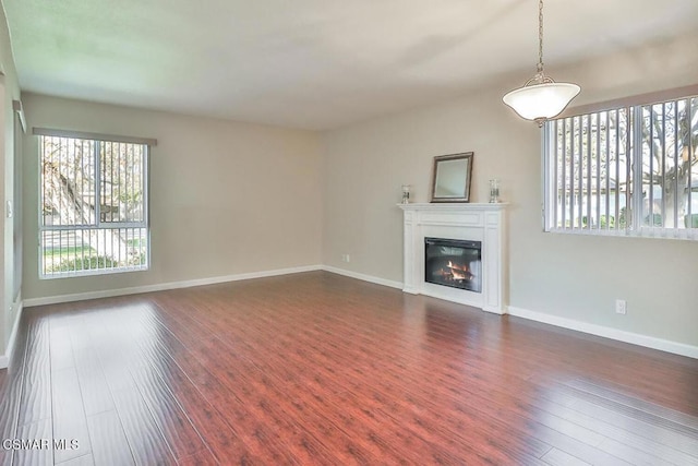 unfurnished living room featuring dark hardwood / wood-style flooring