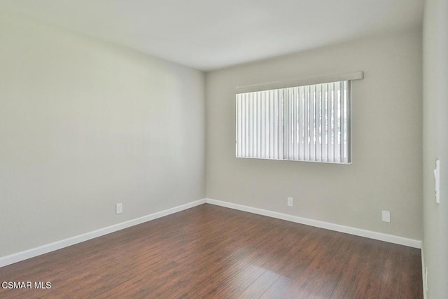 unfurnished room featuring dark hardwood / wood-style flooring