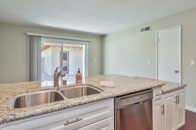 kitchen featuring light stone countertops, white cabinets, dishwasher, dark wood-type flooring, and sink