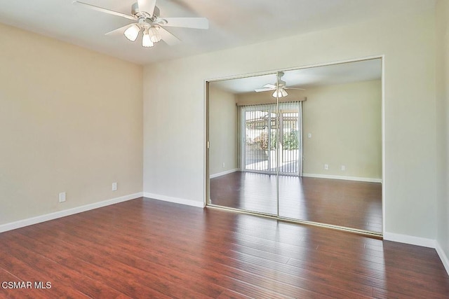 unfurnished room featuring ceiling fan and dark hardwood / wood-style floors