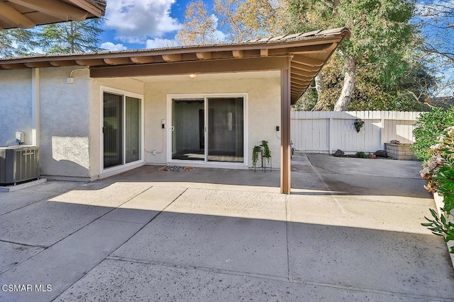 rear view of property featuring cooling unit and a patio