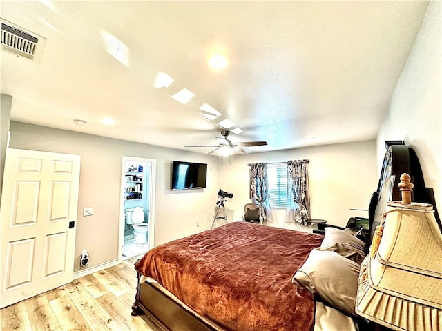 bedroom with ceiling fan, light hardwood / wood-style flooring, and ensuite bath