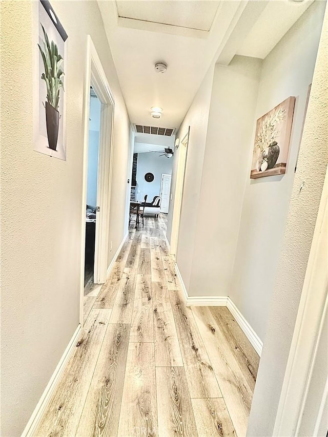 hall with light hardwood / wood-style floors