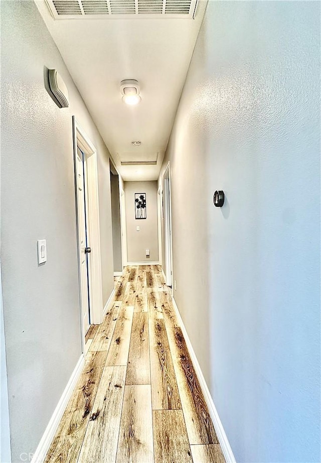 corridor with light wood-type flooring