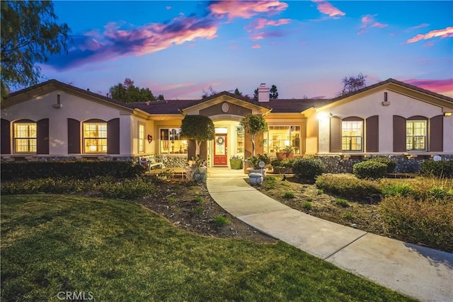 mediterranean / spanish-style house featuring a lawn