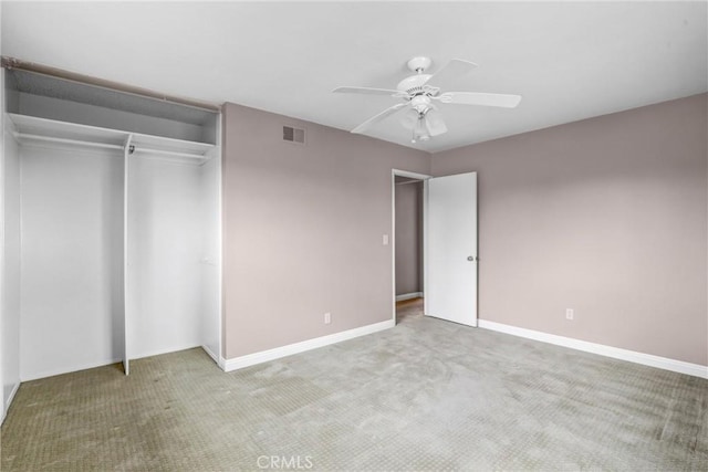 unfurnished bedroom featuring carpet floors, a closet, and ceiling fan