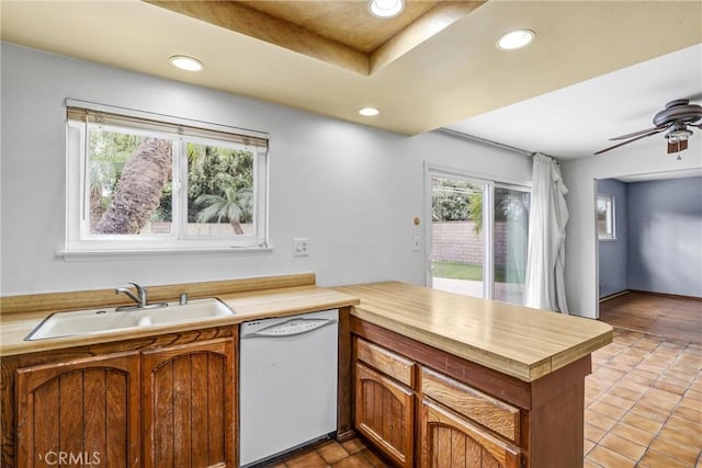 kitchen with sink, light tile patterned floors, dishwasher, ceiling fan, and kitchen peninsula