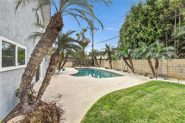 view of swimming pool with a yard, a patio area, and a fenced backyard