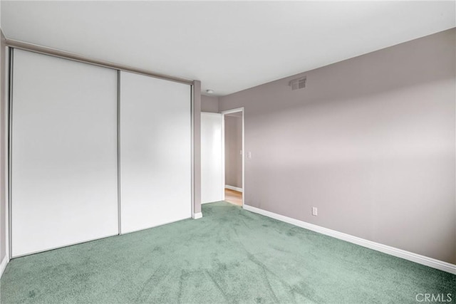 unfurnished bedroom featuring carpet floors and a closet