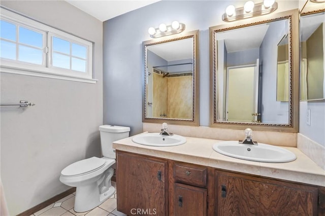 bathroom featuring vanity, tile patterned floors, and toilet