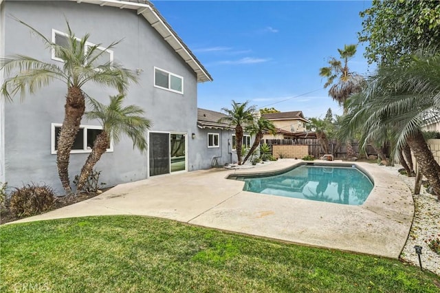 view of swimming pool featuring a patio area and a lawn