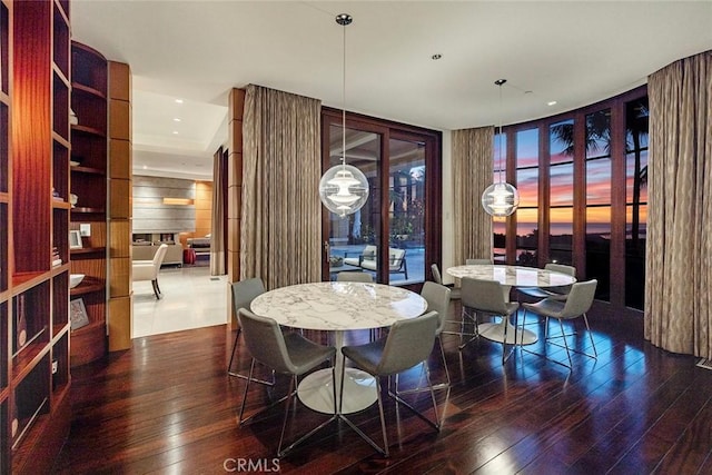 dining room featuring dark wood-type flooring and expansive windows