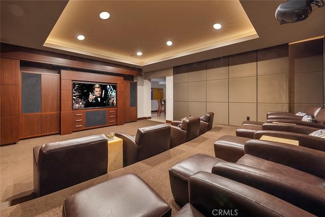 carpeted home theater with a raised ceiling