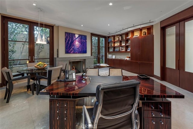 office featuring a premium fireplace, track lighting, and french doors