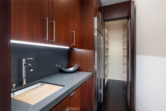 kitchen with sink, high end refrigerator, and dark hardwood / wood-style floors