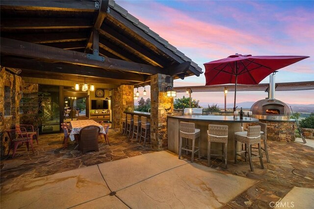 view of patio with a gazebo and an outdoor bar